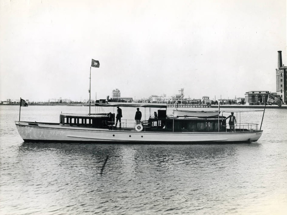 side view of a short and slender boat on a wide body of water side view of a short and slender boat on a wide body of water
